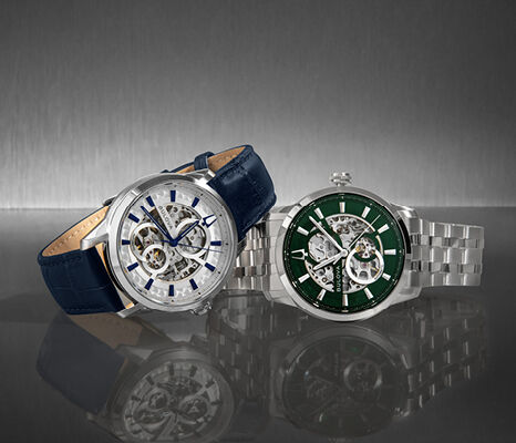 Bulova automatic skeleton watches with open-heart dials &ndash; one on blue leather strap and one with green dial on steel bracelet.